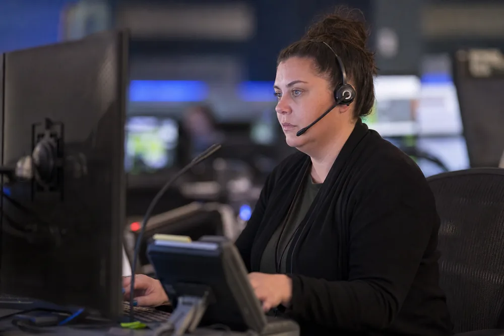 Student telecommunicator practicing with a training headset and console